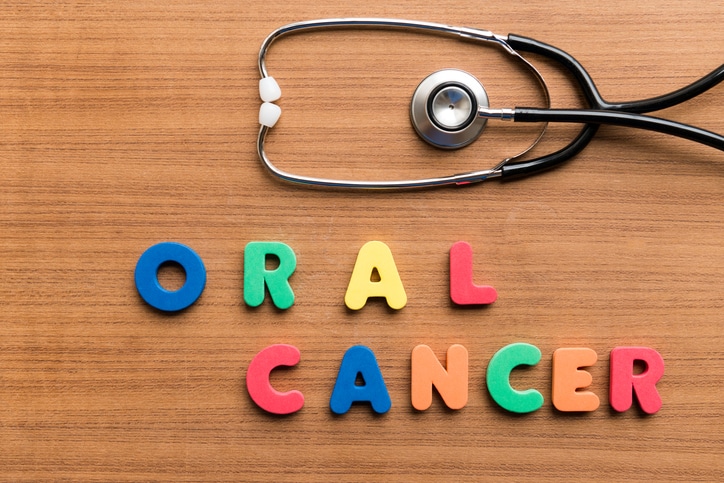 oral cancer colorful word with stethoscope on wooden background