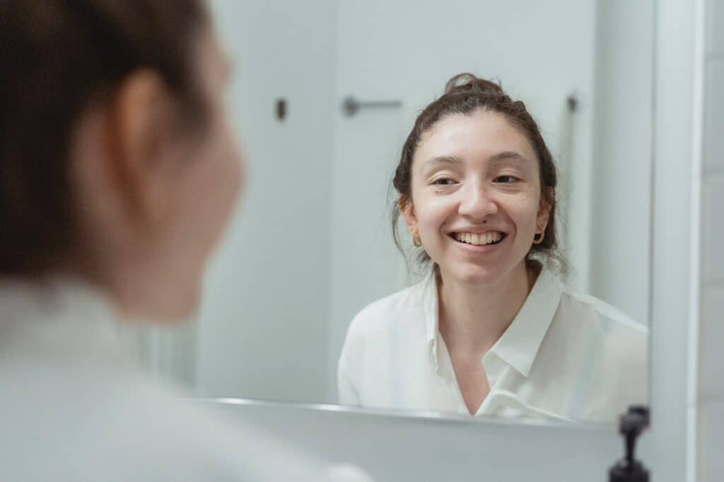 woman looking at mirror