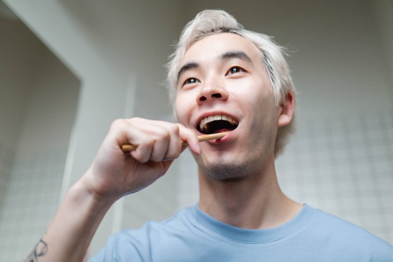 man brushing teeth
