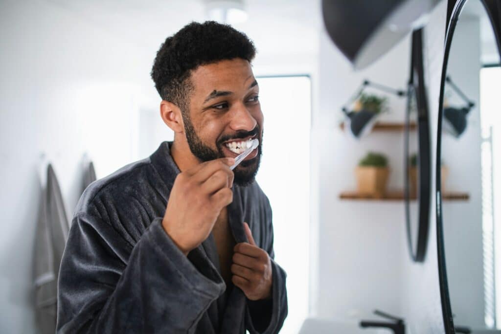 man brushing teeth